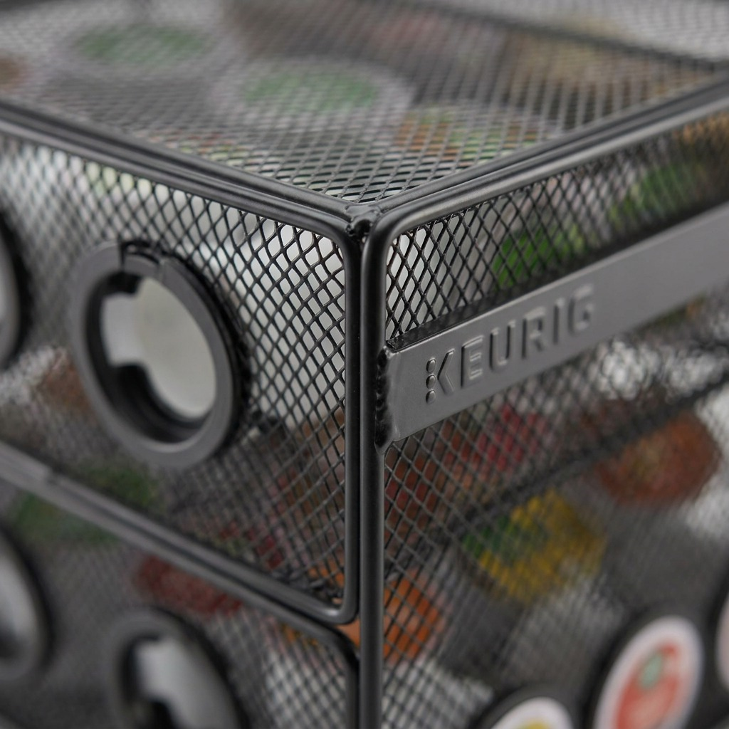Extreme macro photo showing the fine texture of the black wire mesh and clear Keurig branding on the rack.