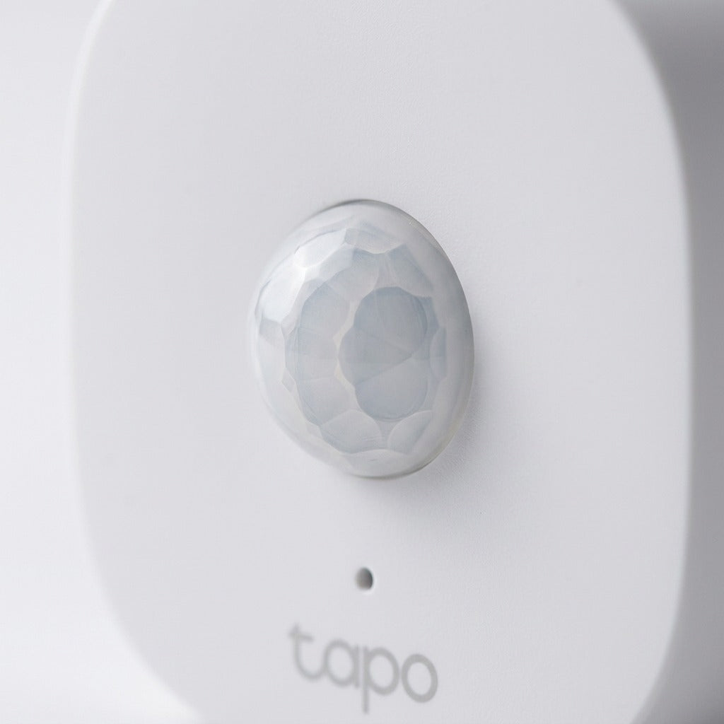 Macro close-up of the TP-Link Tapo T100 Smart Motion Sensor lens and matte white finish.