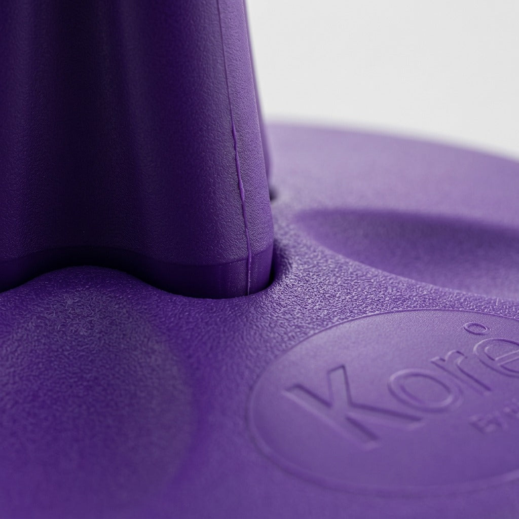 Macro detail of the purple Kore Toddler Wobble Stool showing the textured antimicrobial plastic.