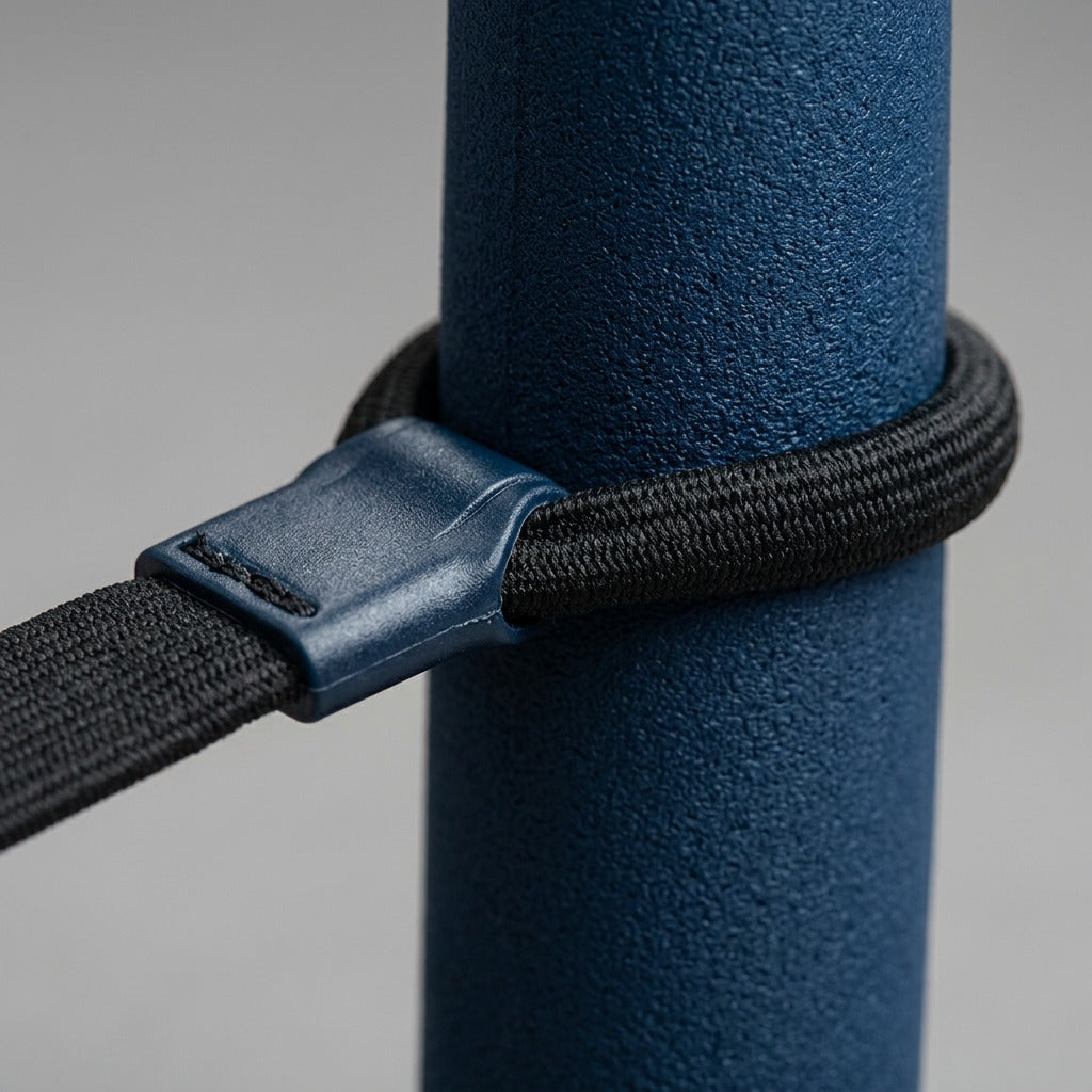 Macro detail of fdmt Bouncyband connector and black textured cord around a blue foam desk leg sleeve.