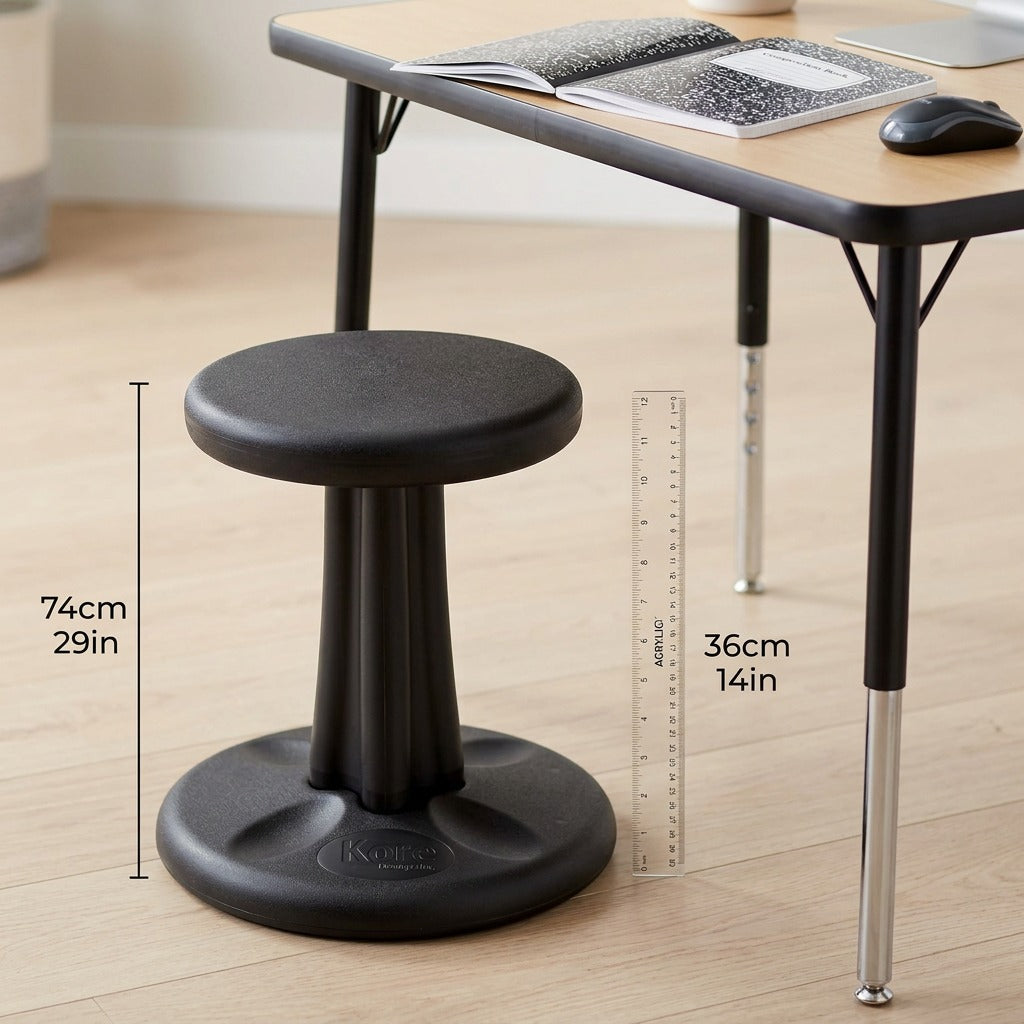 Black 36cm fdmt Kore Wobble Stool next to a desk and ruler to show 14-inch height for scale.