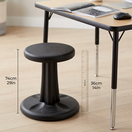 Black 36cm fdmt Kore Wobble Stool next to a desk and ruler to show 14-inch height for scale.