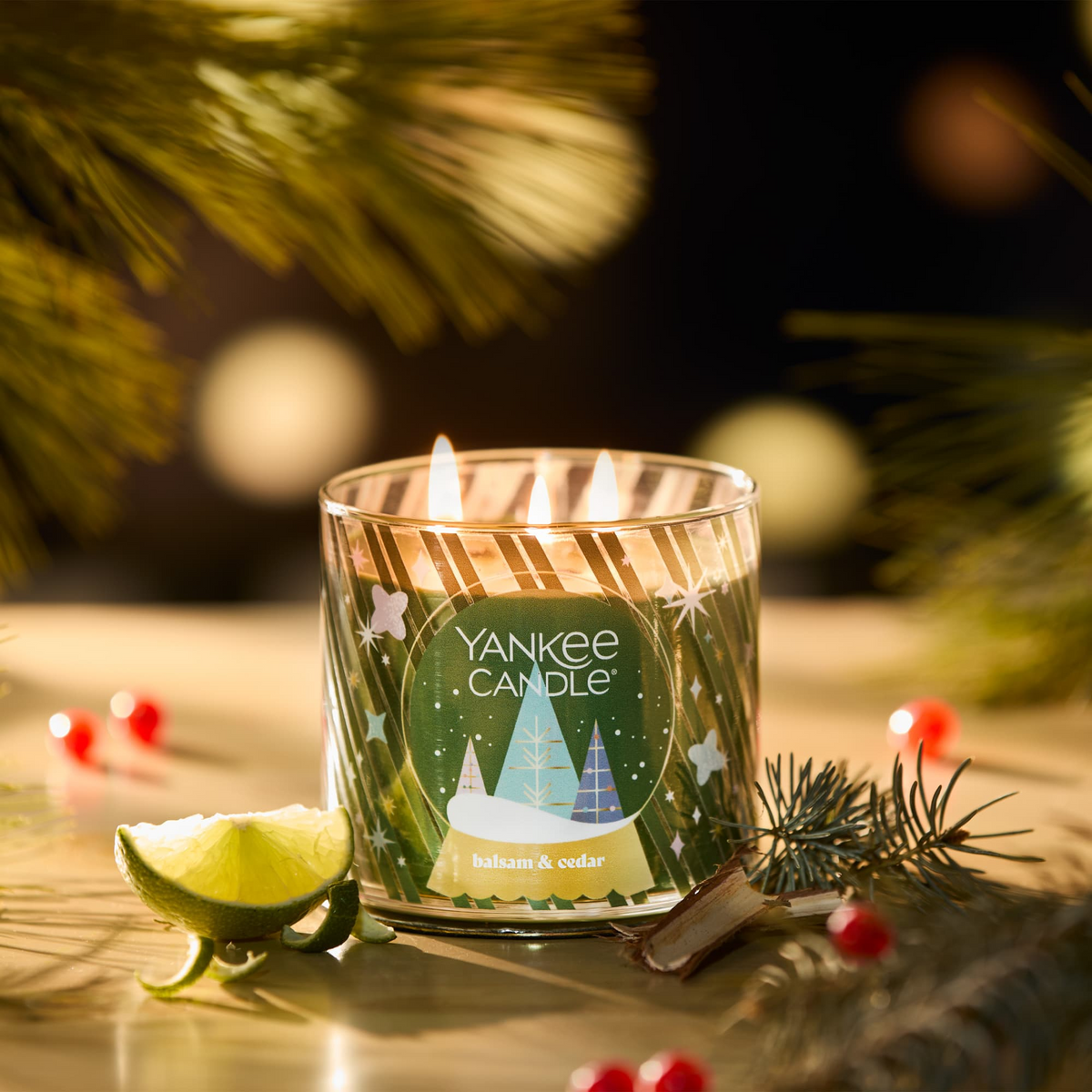 Yankee Candle Balsam & Cedar 3-Wick Candle lit in a holiday setting